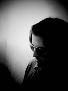 Black and white photo of person with sunglasses.