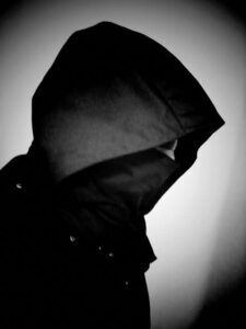 Black and white photo/self portrait wearing hooded cowl.