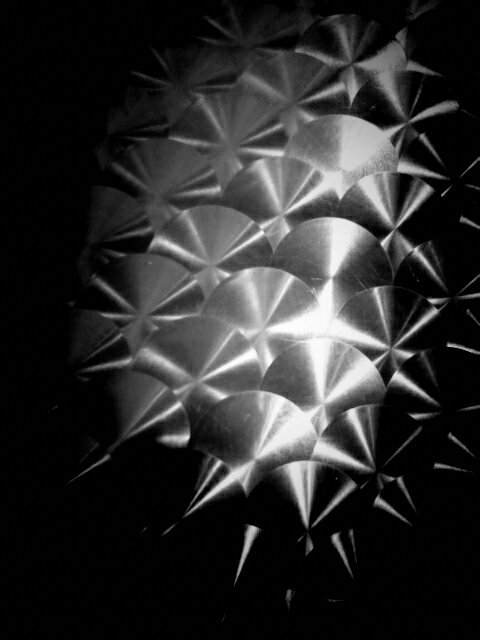 Black and white photo of a metallic pattern.