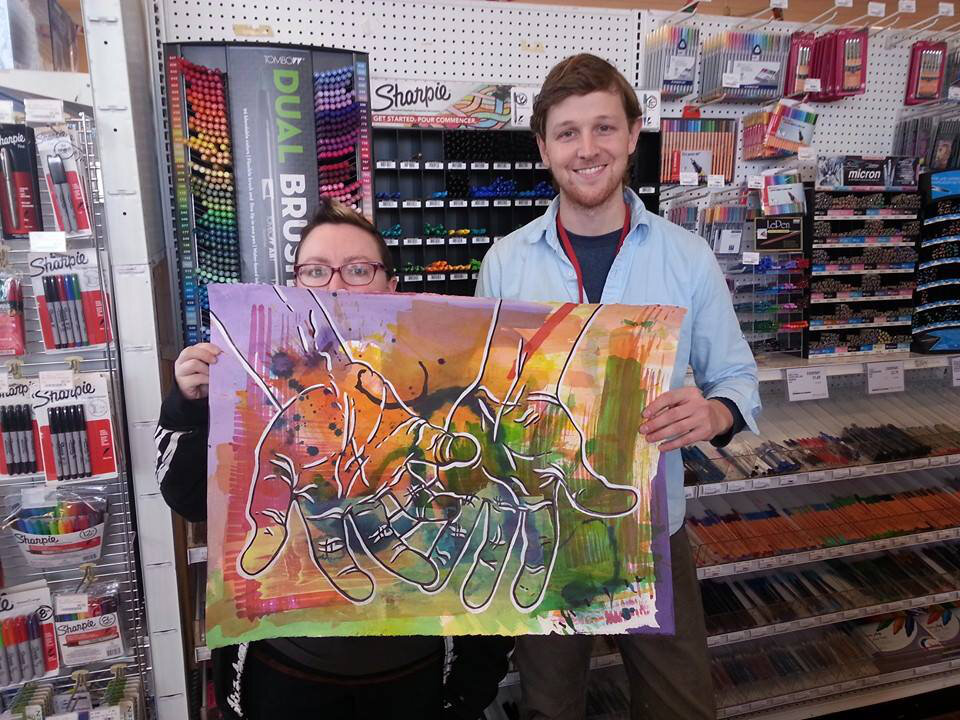 Ren and Eric holding the finished art.