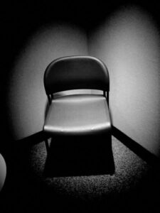 Black and white photo of chair at the therapist office.