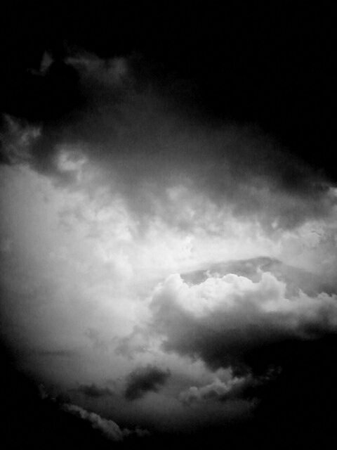 Black and white photo of clouds in sky.