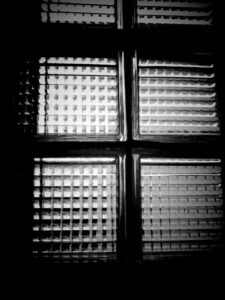 Black and white photograph of glass blocks in a warehouse.