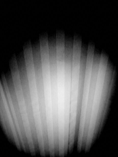 Black and white photo of dirty striped glass.