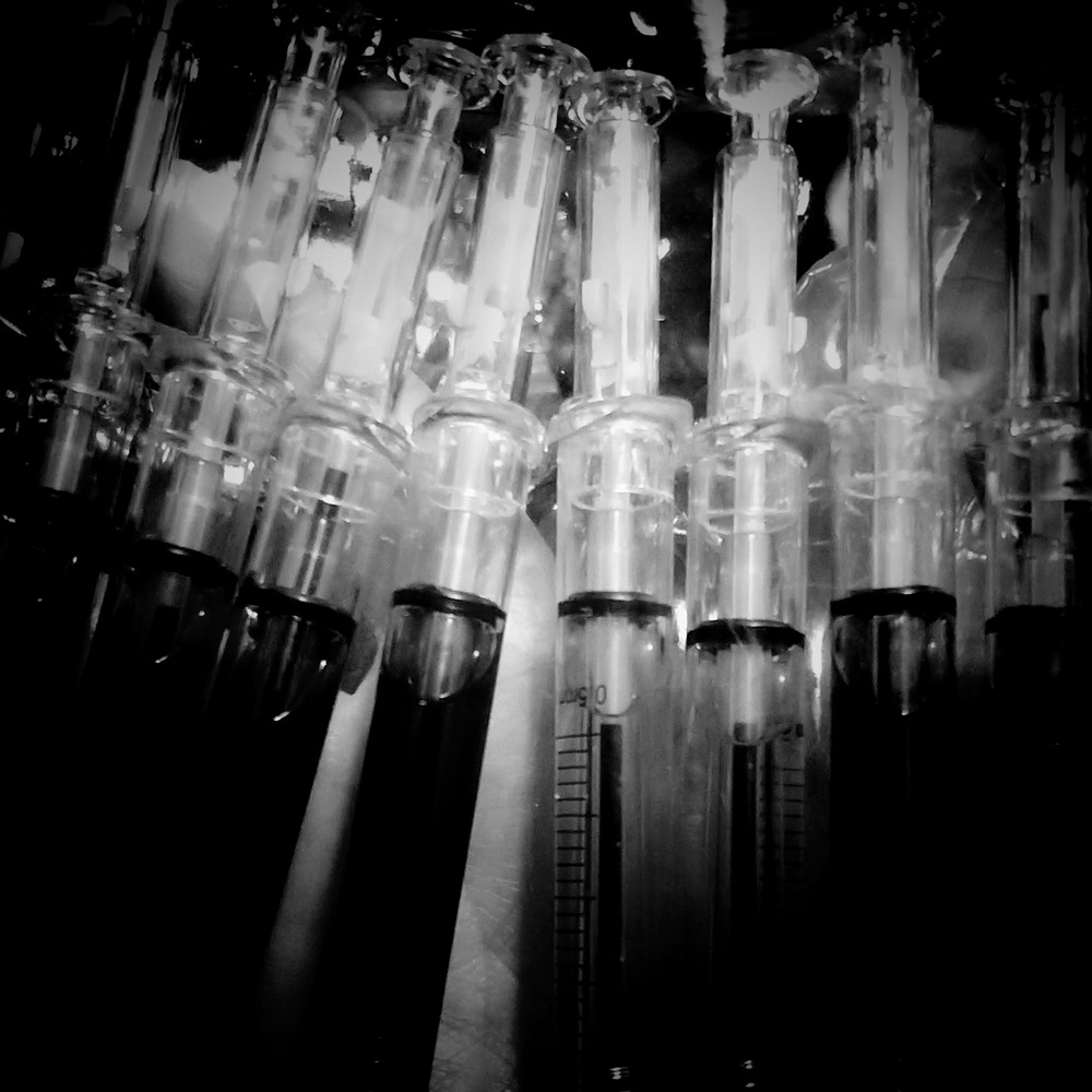 Black and white photo of syringes.