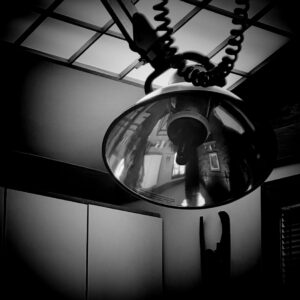 Black and white photo of fixture with cord.