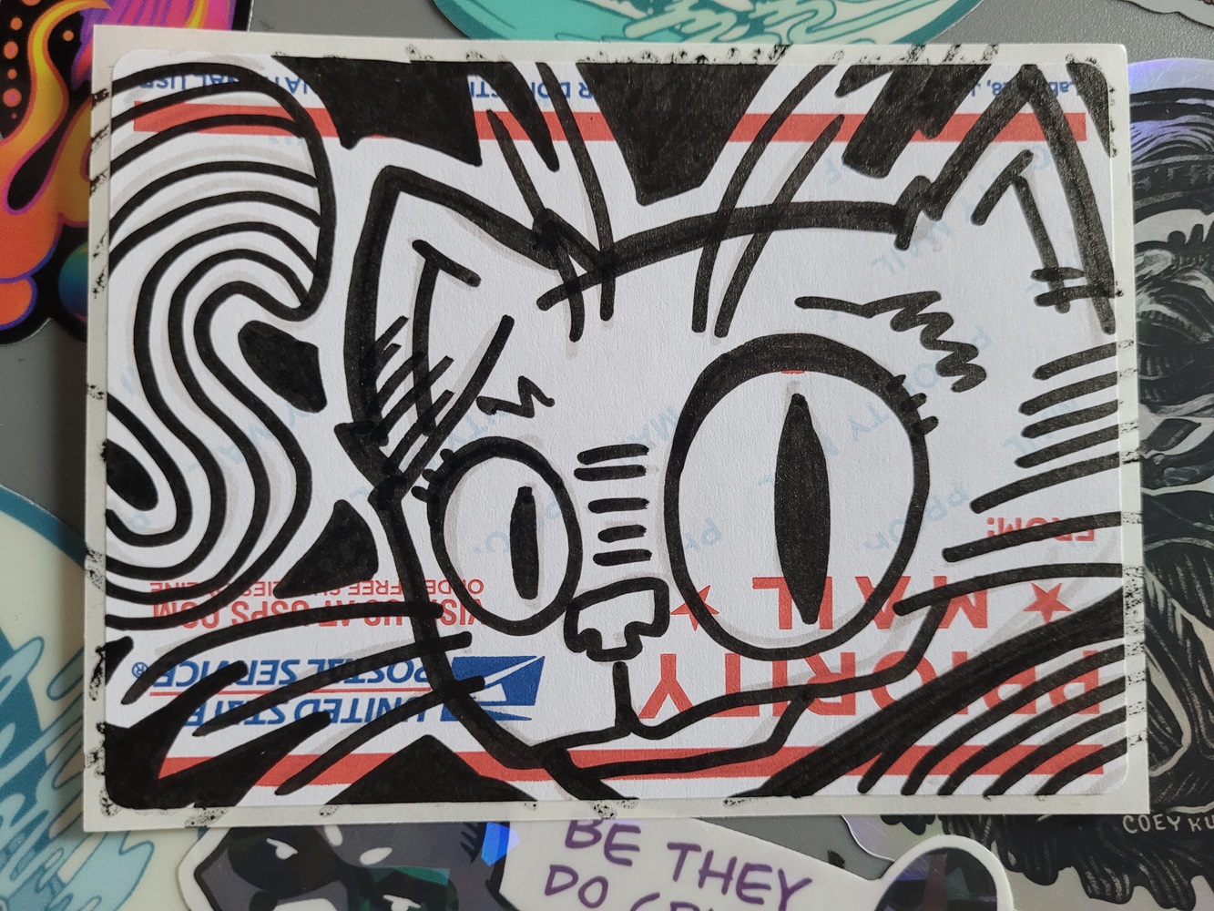 Marker art of cat drawn on sticker.