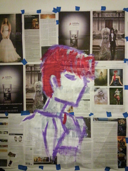 Photo of red added to work in progress painting on newspaper taped to wall.