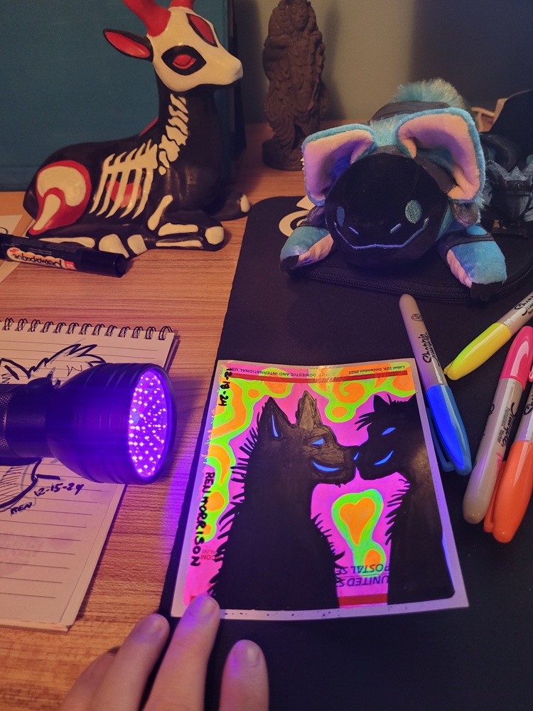 Photo of my art workspace for using blacklight/UV markers on drawings.